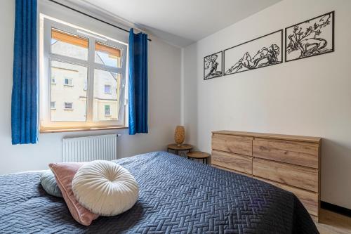 a bedroom with a bed with a pillow on it at Plac Solny 4 Discreet&Comfort Głogów in Głogów