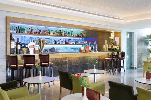 a bar in a restaurant with tables and chairs at Muthu Clube Praia da Oura in Albufeira
