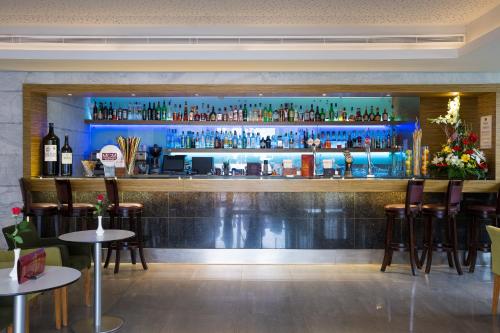 a bar with a lot of bottles on the wall at Muthu Clube Praia da Oura in Albufeira