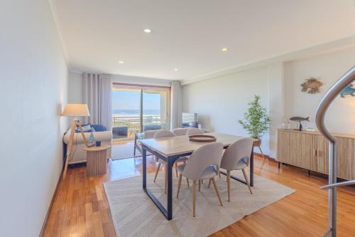 a dining room with a table and chairs at Ocean View Luxury Duplex Apartment in Ovar