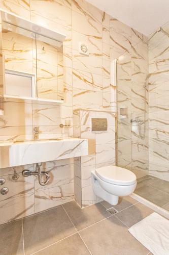 a bathroom with a toilet and a sink at Apartments Obala - Katić in Herceg-Novi