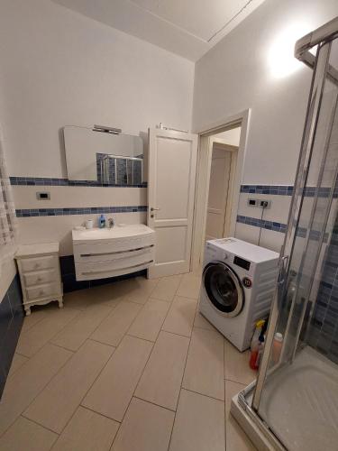 a bathroom with a washing machine and a washer at Agriturismo La Fine in Piancaldoli
