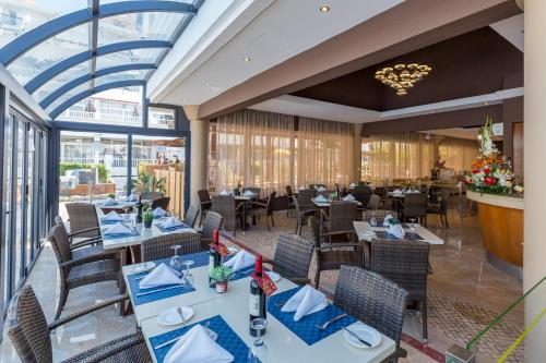 a dining room with tables and chairs in a restaurant at Muthu Clube Praia da Oura in Albufeira
