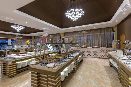 a restaurant with a bunch of food on display at Muthu Clube Praia da Oura in Albufeira