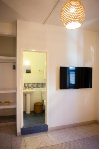 a bathroom with a mirror and a sink and a toilet at Casa Origen in Oaxaca City