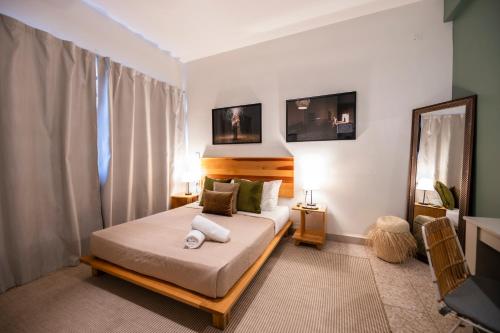 a bedroom with a bed with two towels on it at Casa Origen in Oaxaca City