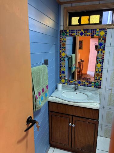 a bathroom with a sink and a mirror at Casa Mañío Hostal Castro in Castro