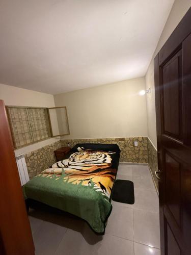 a bedroom with a bed in the corner of a room at complejo laprida in Santa Lucía