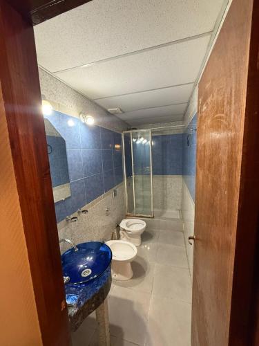 a bathroom with a toilet and a sink at complejo laprida in Santa Lucía