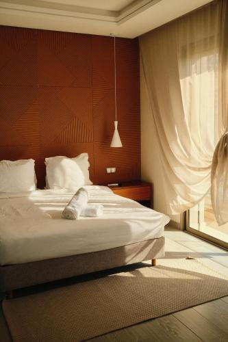 a bedroom with a bed and a window at YMY Beach House in Agadir