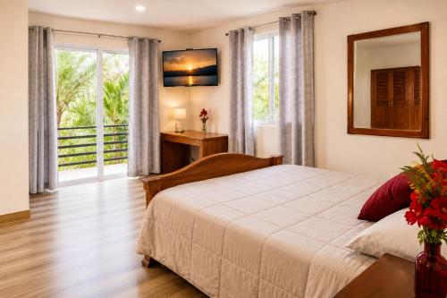 a bedroom with a bed and a large window at COCOVIEW Hotel in Valle de Ángeles