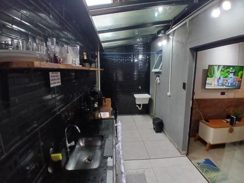 a bathroom with a sink and a toilet at Apartamento em juquehy in São Sebastião