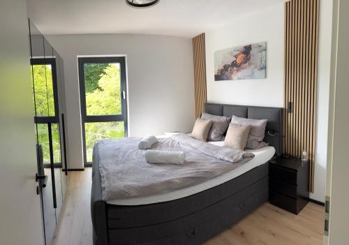 a bedroom with a large bed in a room at Design-Villa mit privatem Whirlpool&Naturblick in Wellheim