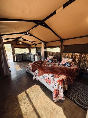 a bedroom in a tent with a bed in it at Orpheus Inn & Glamping in Kaneb Pos