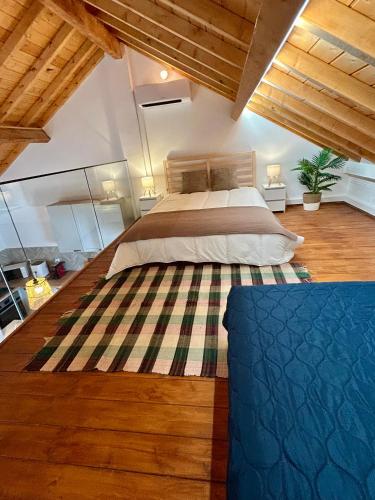 a bedroom with a large bed in a room with wooden ceilings at Casas Morgado in Valada