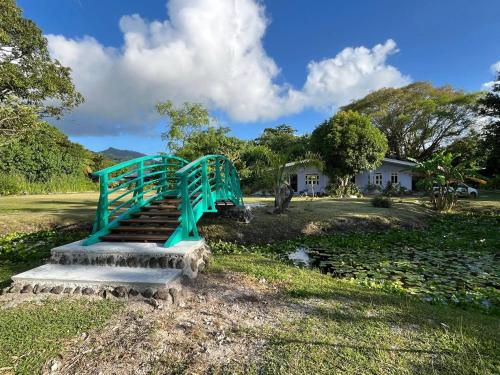 a blue metal staircase in a yard with a house at Waterlily House in HUH