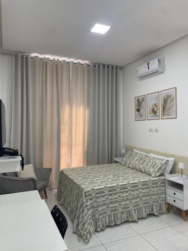 a bedroom with a bed and a television in it at Pousada Imperial in Seabra