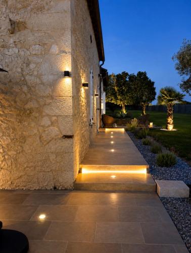 a pathway leading to a building with lights on it at Luxury home private duras in Duras