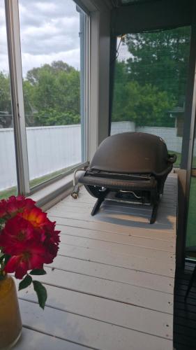 a grill sitting on a porch next to a window at Spacious & Sun-Filled Highlands Retreat in Moss Vale