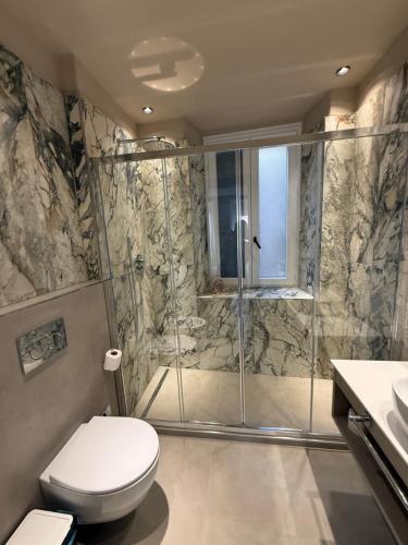 a bathroom with a shower and a toilet and a sink at CAST AWAY in Riomaggiore
