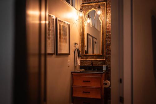 a bathroom with a sink and a mirror at The Luxe Loft Knoxville in Knoxville