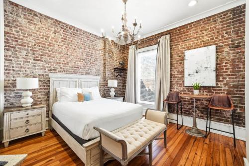 a bedroom with a brick wall at The Luxe Loft Knoxville in Knoxville