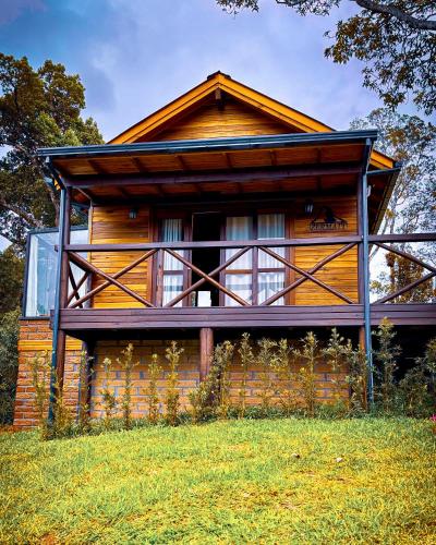 a wooden house with a large window on the side of it at Cabana Zermatt in Timbe do Sul