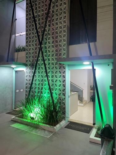 a lobby with green lights in a building at Pousada Imperial in Seabra