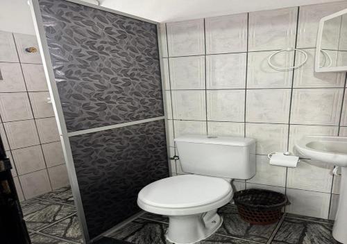 a small bathroom with a toilet and a sink at Margarida AP 3 in Presidente Figueiredo