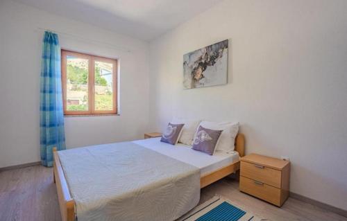 a bedroom with a bed and a window at Apartments by the sea Metajna, Pag - 6289 in Zubovići
