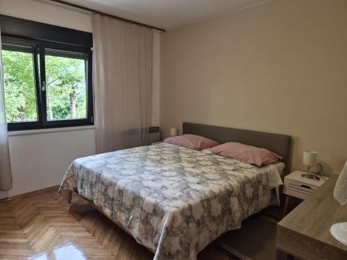 a bedroom with a bed and a window at Apartments with parking space Moscenicka Draga, Opatija - 2346 in Mošćenička Draga