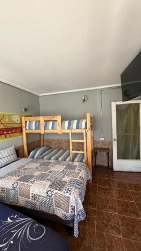 a bedroom with a bed and a flat screen tv at Hostal Copa Arica in Arica