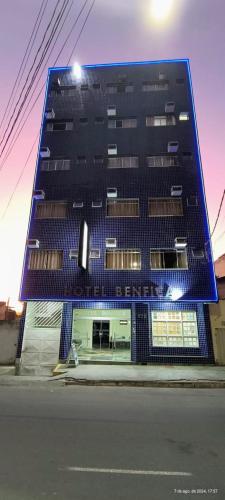 a tall black building on the side of a street at Hotel Benfica in Aparecida