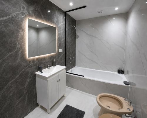 a bathroom with a tub and a toilet and a sink at Urban Berazategui in Berazategui