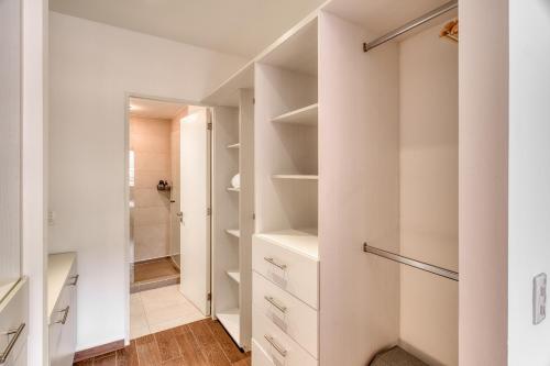 a walk in closet with white walls and white shelves at Nido x Gran Ciudad Nuevo Sur in Monterrey
