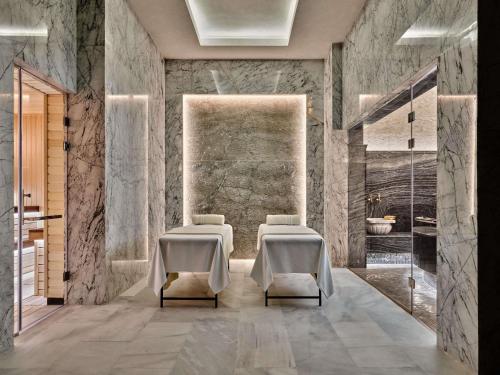 a bathroom with two chairs and a sink at Swissotel Tashkent in Tashkent