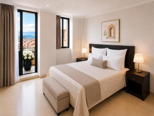 a bedroom with a large bed and a large window at Hotel Mediterraneo Quito in Quito