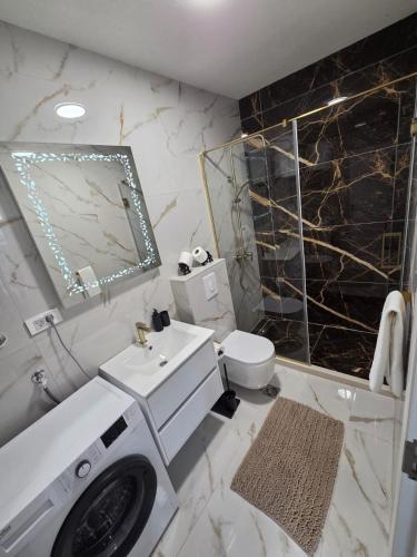 a bathroom with a sink and a toilet and a mirror at Luxury Studio Apartment with Sea View & Heated Pool in Kotor