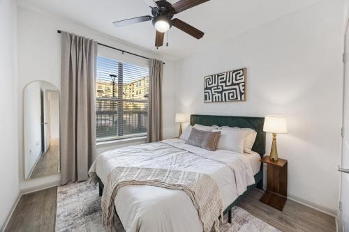 a bedroom with a bed and a window at Relaxing Getaway with Pool view & Gym in Frisco
