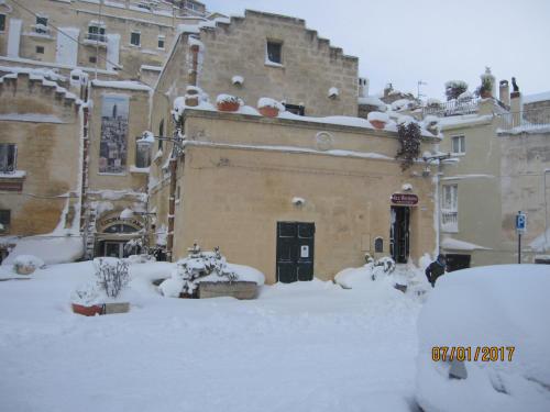 a building covered in snow in a yard at Sax Barisano in Matera