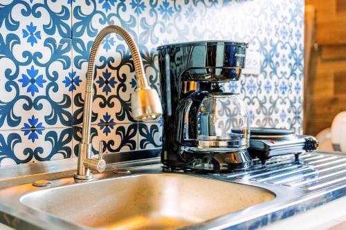 a kitchen sink with a coffee maker on top of it at Villa Verona in Guatemala
