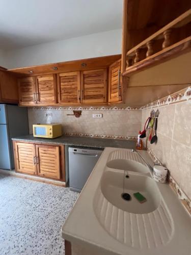 a kitchen with a sink in the middle of it at Villa cleopatra in Mezraya