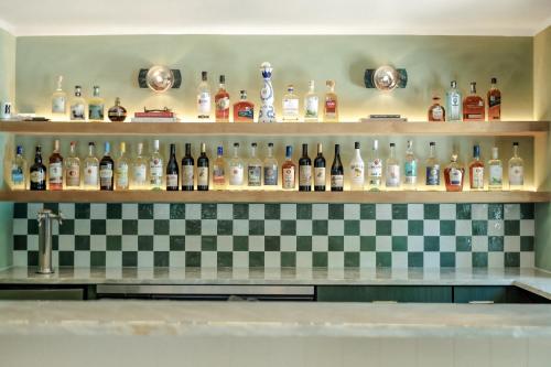 a shelf filled with lots of bottles of alcohol at Petit Cowboy in New Braunfels