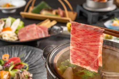 a piece of meat sticking out of a bowl of food at KAMENOI HOTEL Ichinoseki in Ichinoseki