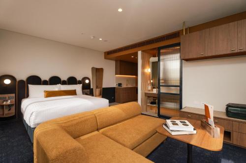 a hotel room with a bed and a couch at Hotel Panorama in Clapham