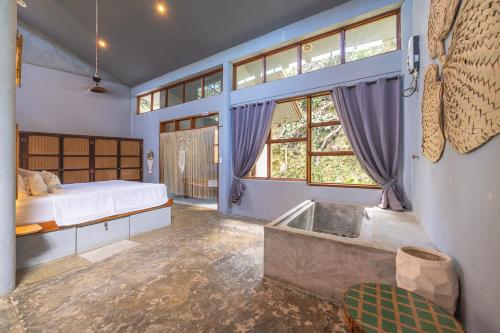 a bedroom with a bed and a tub in it at Union House with generator in Dapa