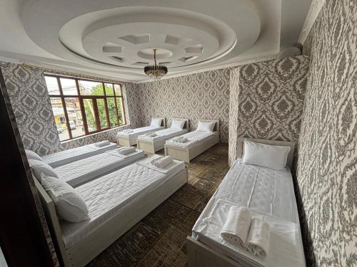 a room with a bunch of beds in it at Geniuses in Samarkand