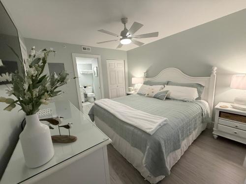 a bedroom with a bed and a ceiling fan at Beachfront Condos in Destin in Destin