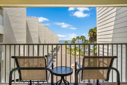 two chairs on a balcony with a view of the ocean at Bayfront 2BR2BA Condo at Sailport Minutes from Beaches & Downtown Attractions in Tampa