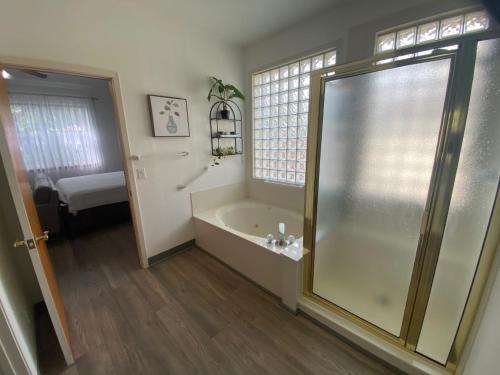 a bathroom with a shower and a bath tub at Delaware Springs Home in Burnet